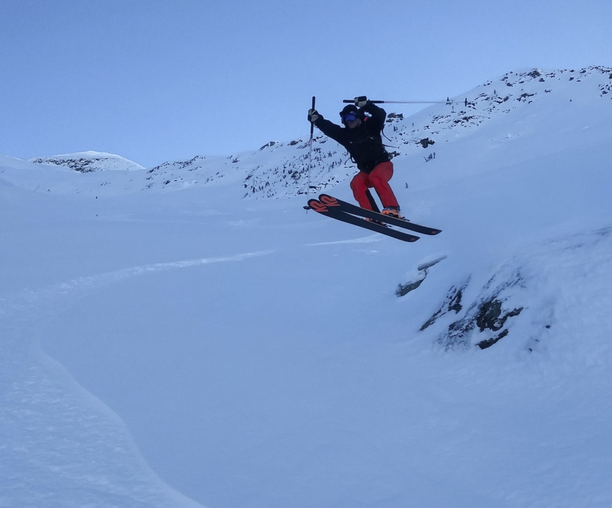 skier jumping off rock