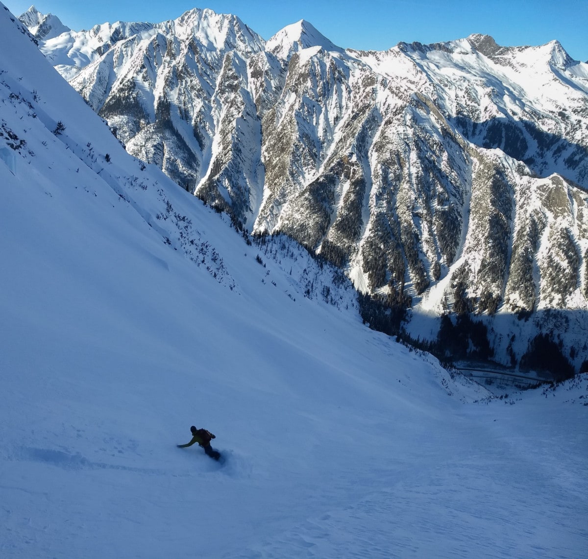 snowboader racing down the green glacier