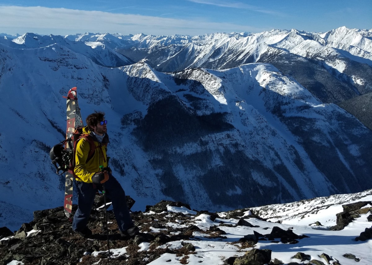 splitboarder hiking ridge after ross pass