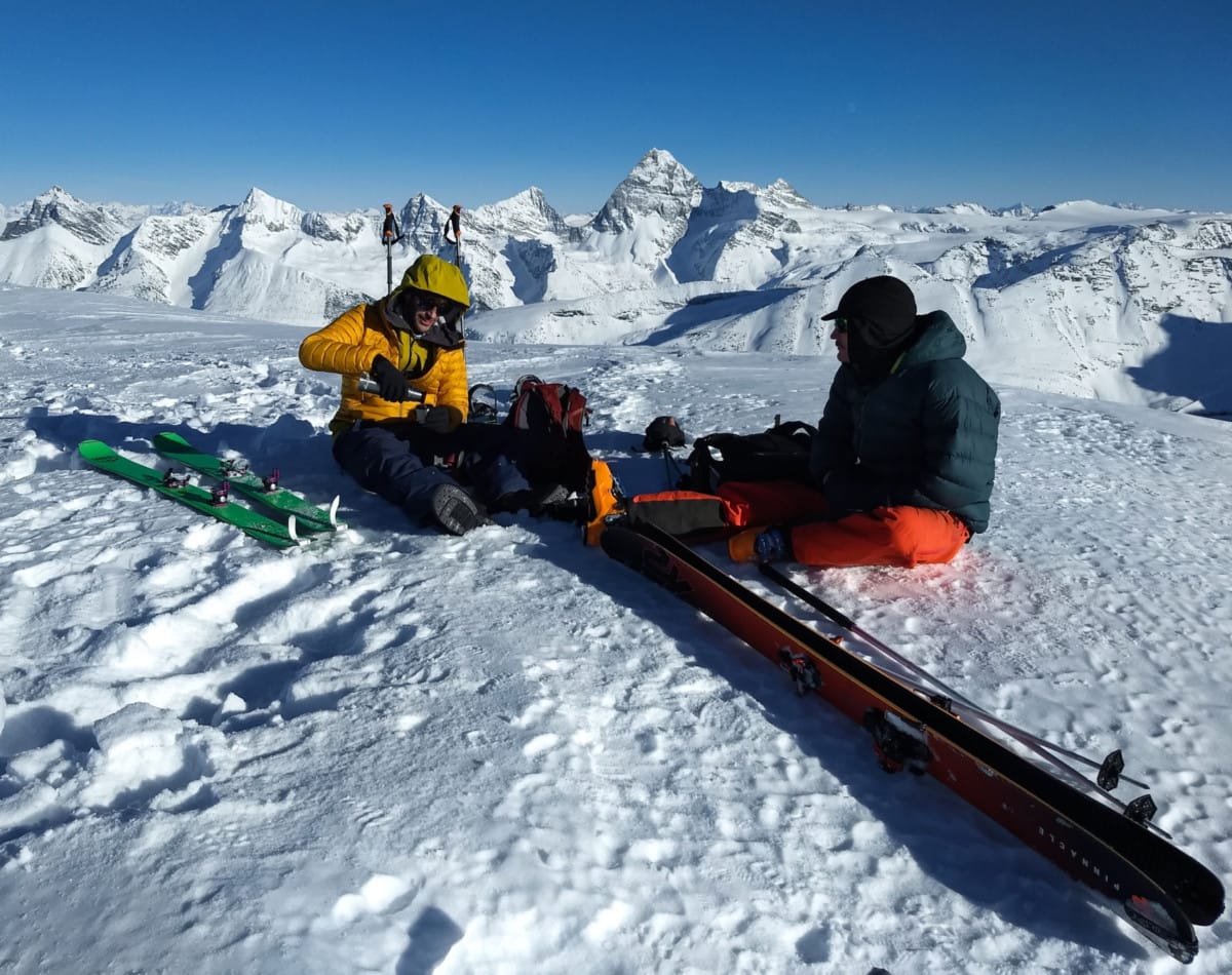 two mountaineers enjoying coffee on mt green summit