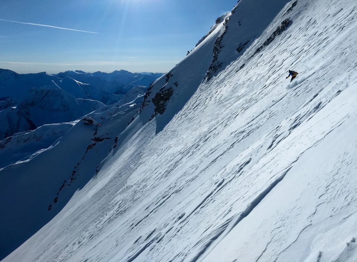 backcountry skier making its way down rogers col