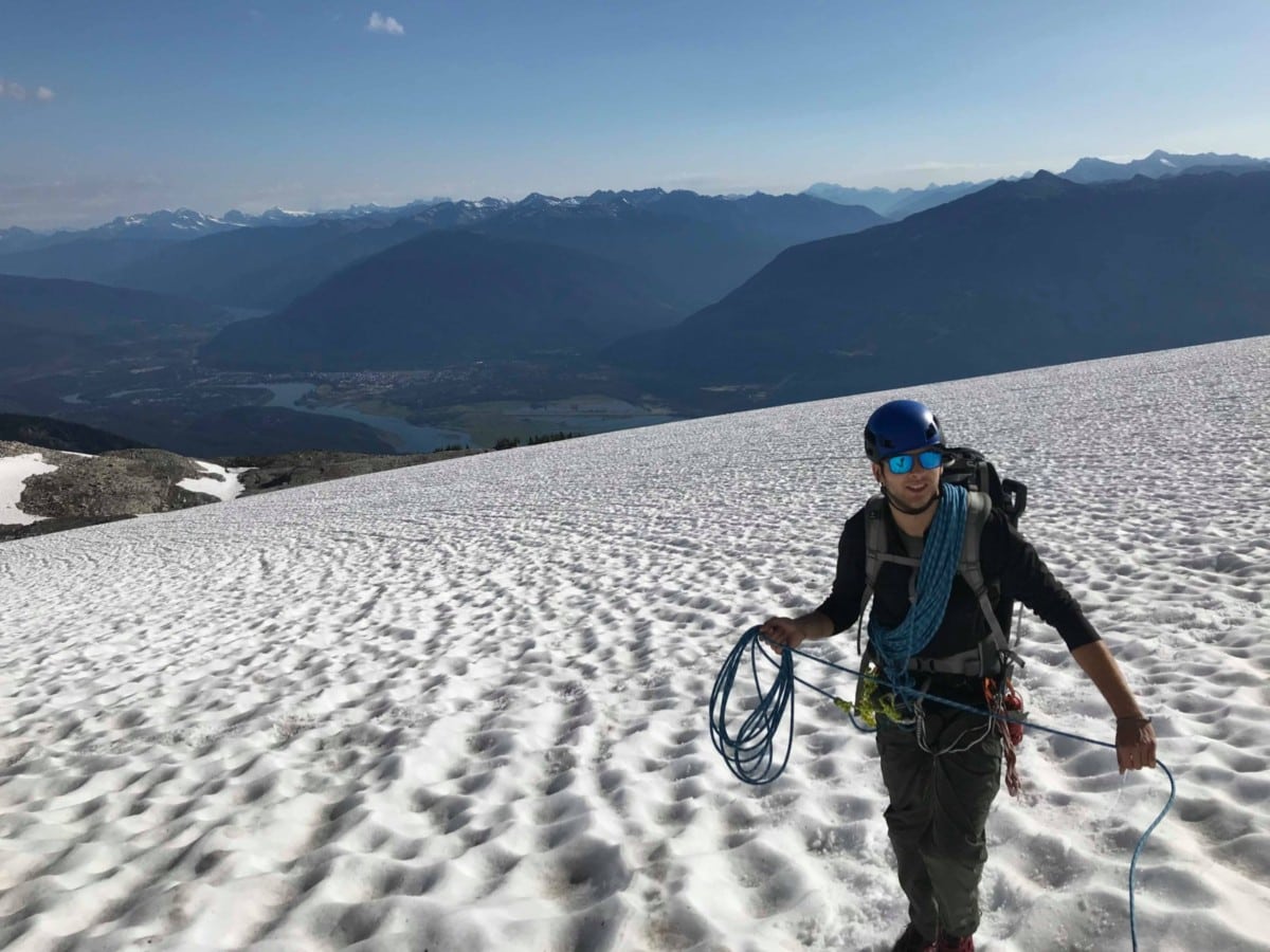 man crossing the begbie glacier with rope