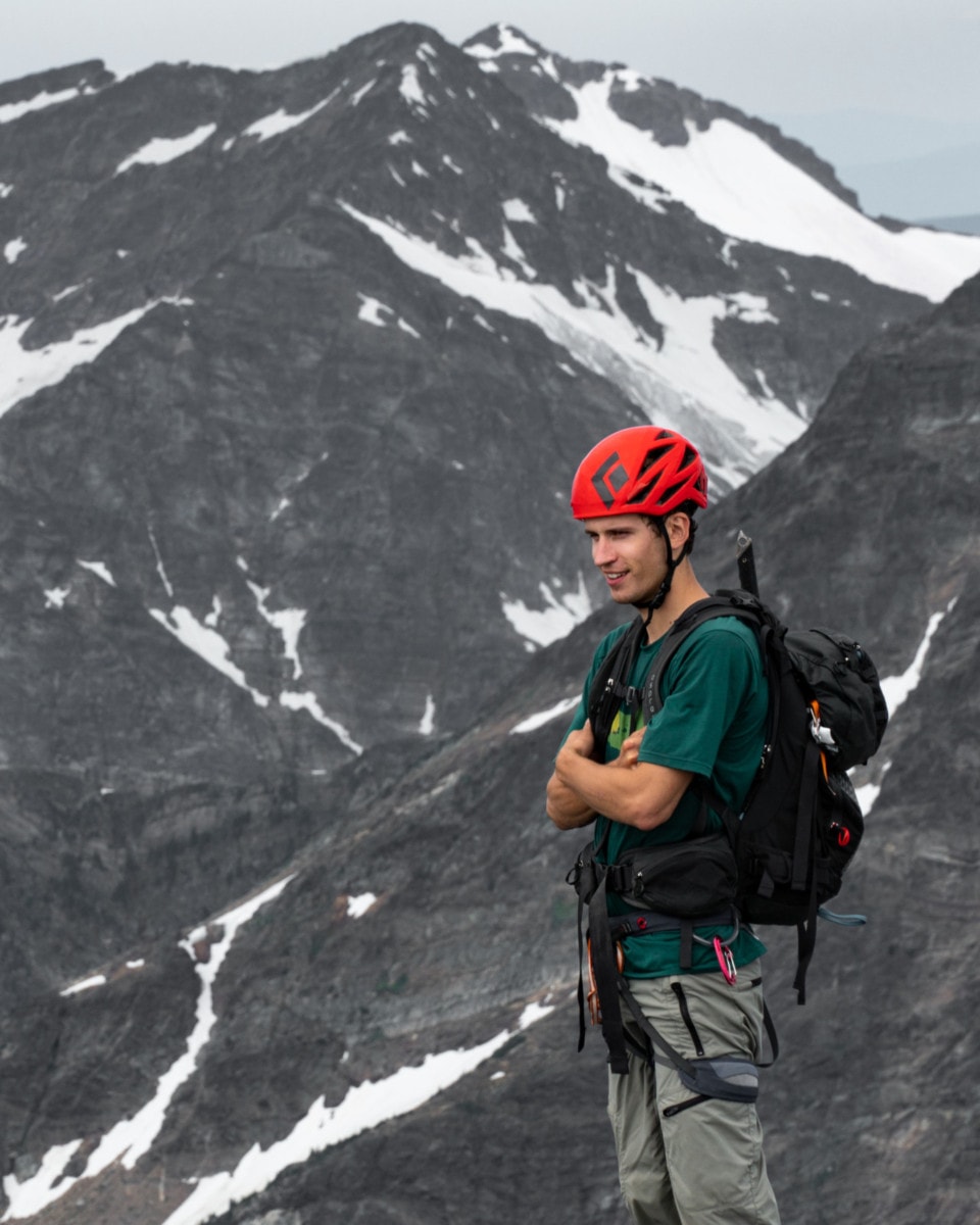 mountaineer on top of mt begbie looking into the distance