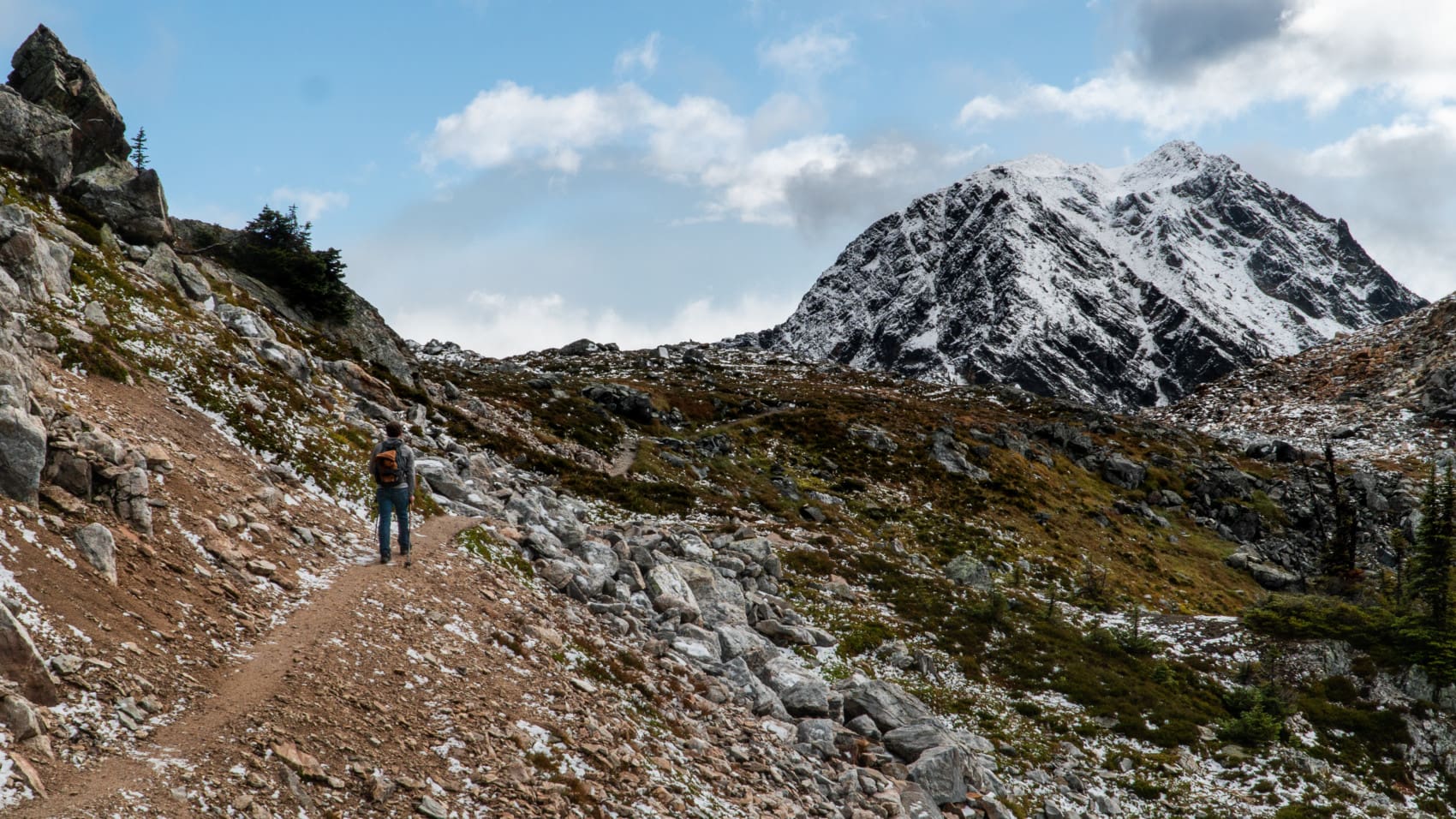 hiker with inverness southwest peak in the back