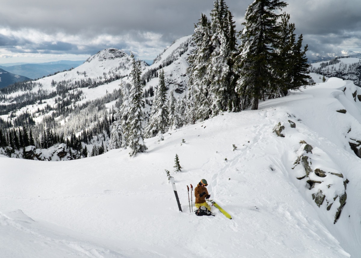 skier preparing his gear for skiing down