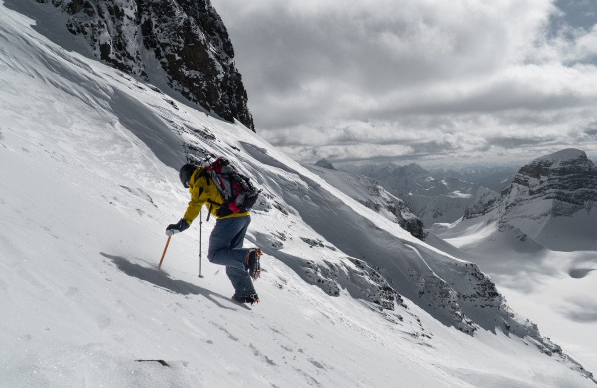 man hiking up the west slope of mt daly