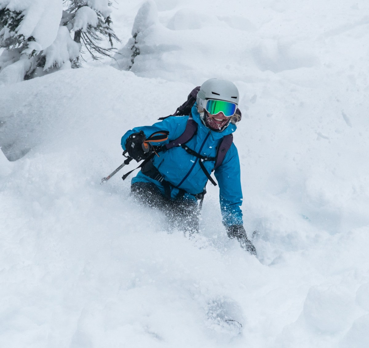 skier slashing powder on rogers run