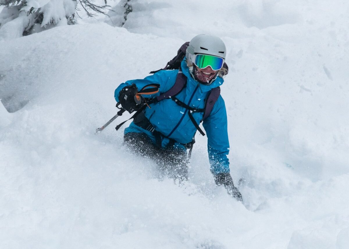 skier slashing powder on rogers run