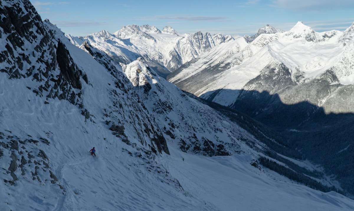 skier craving a turn in shit snow with glacier national park in the background