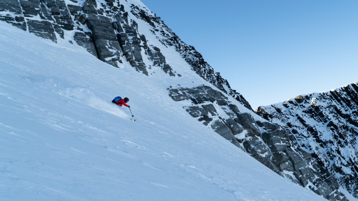 skier slashing powder on the dome glacier in rogers pass