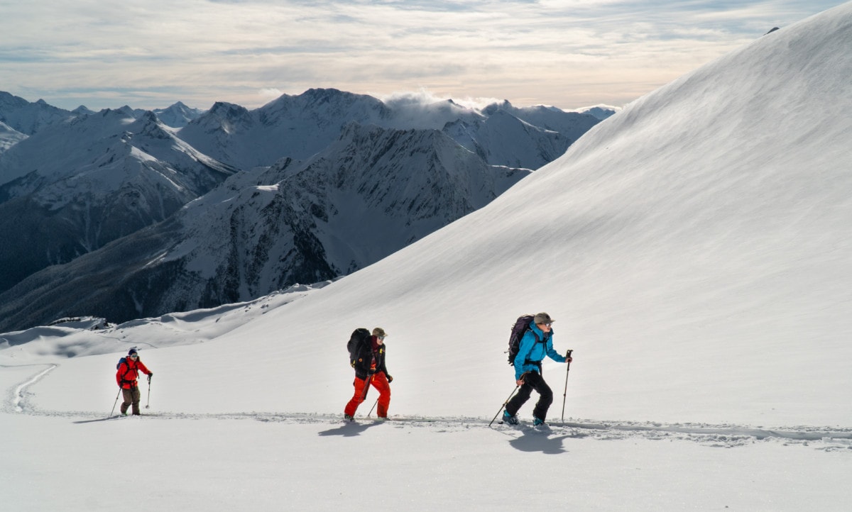 skiers ascending a snowy slope in rogers pass test