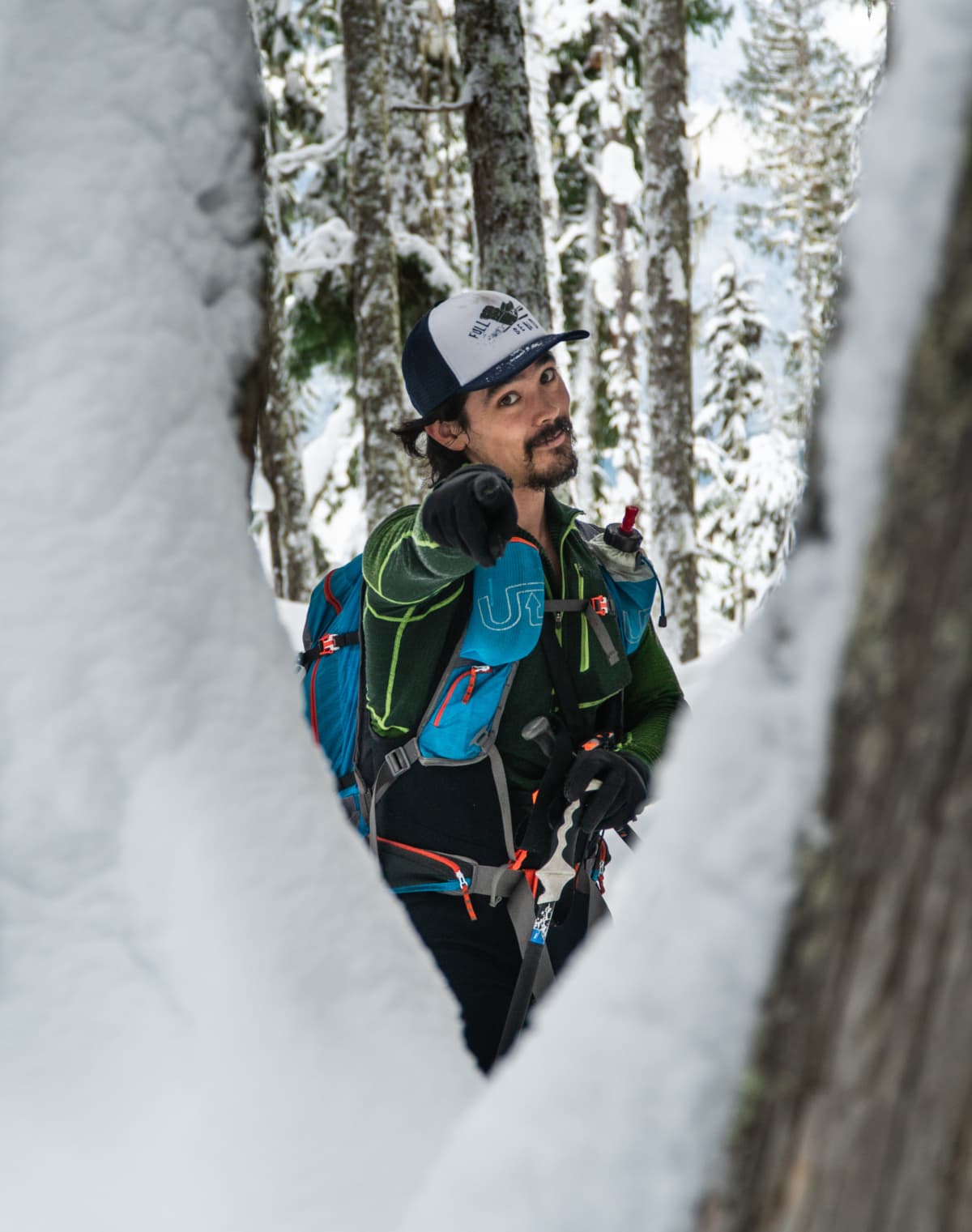 man pointing at camera while in the woods near revelstoke 1