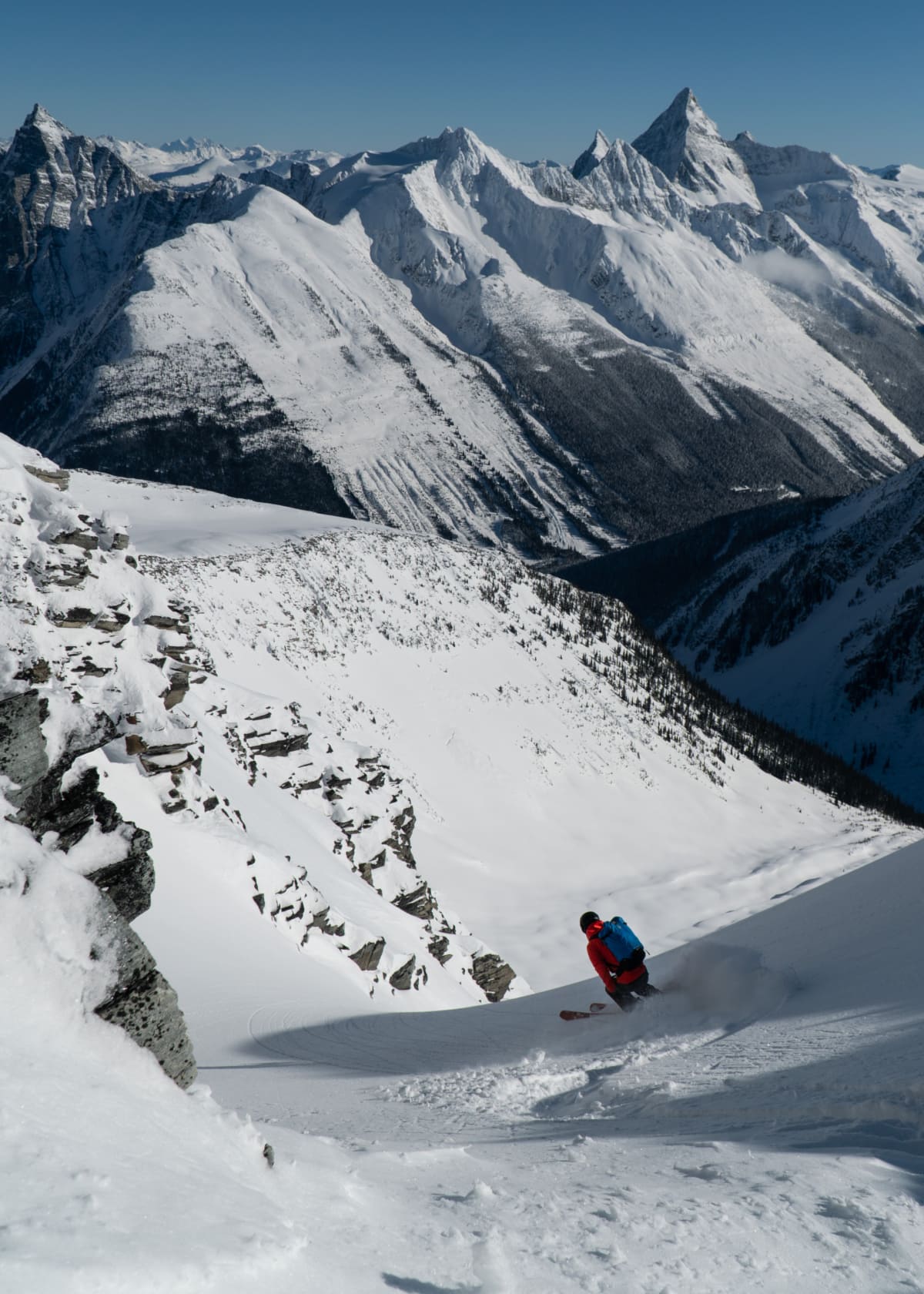 skier slashing a turn down a couloir in the alpine