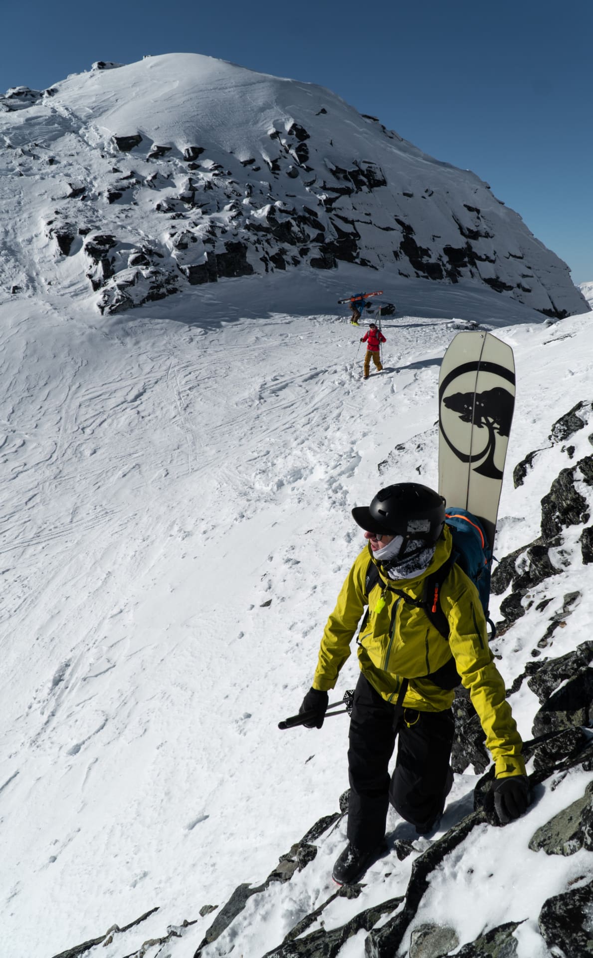 splitboarder scrambling on rocks in rogers pass