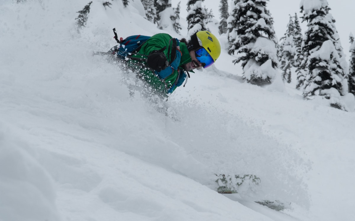 happy skier slashing some powder