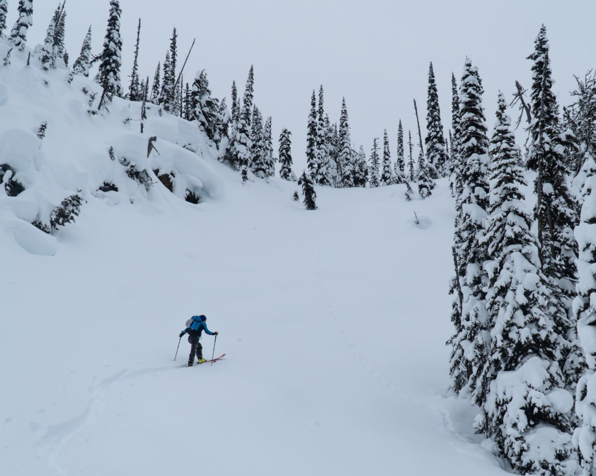 man in snow reaching corbing pass