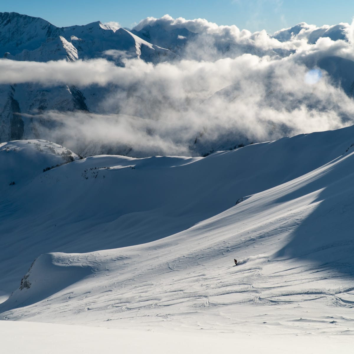 skier descending 881 bowl in rogers pass