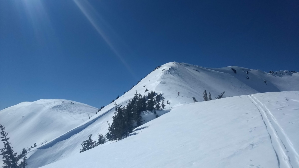 man ascending a ridge out of the elm valley