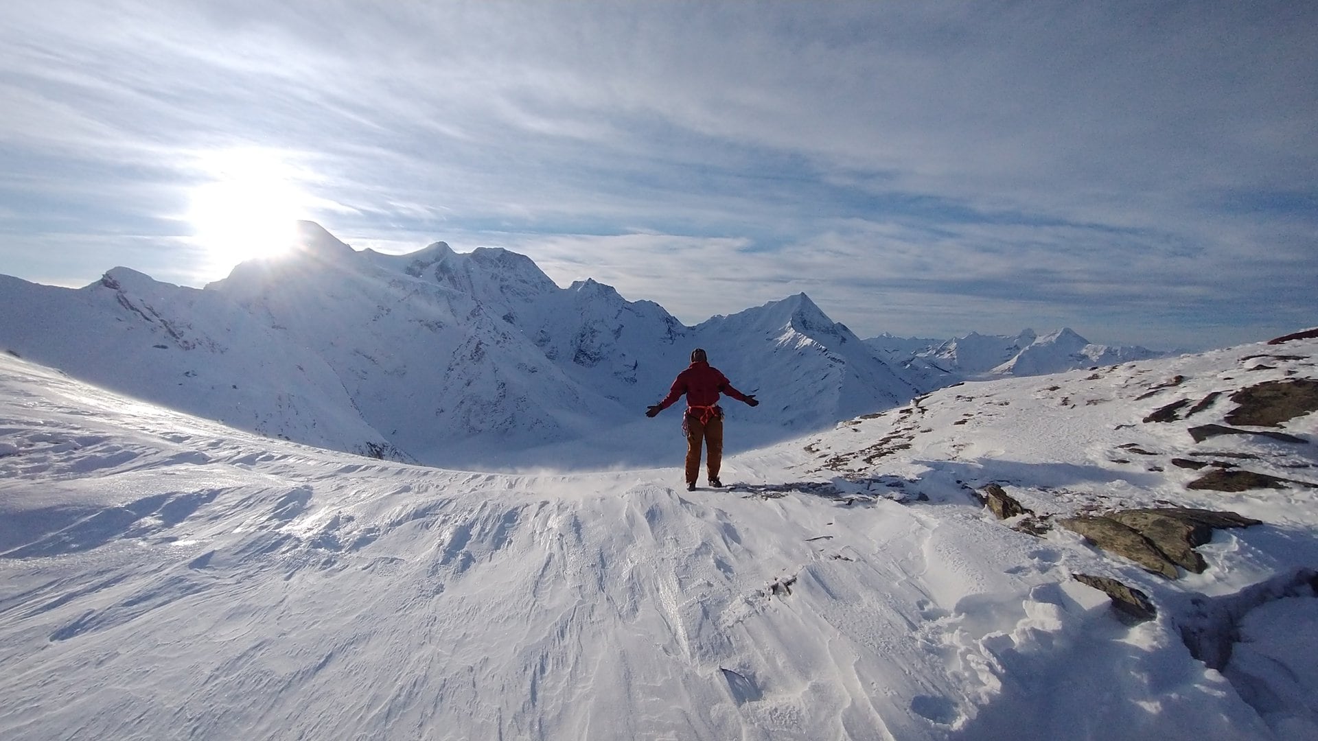 man happy to have reached the asulkan pass in the winter