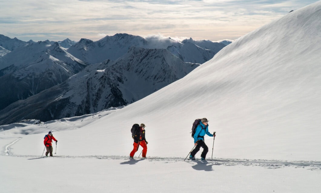 three skiers skiing in rogers pass on the little sifton traverse