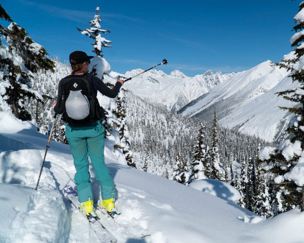 skier pointing towards a peak