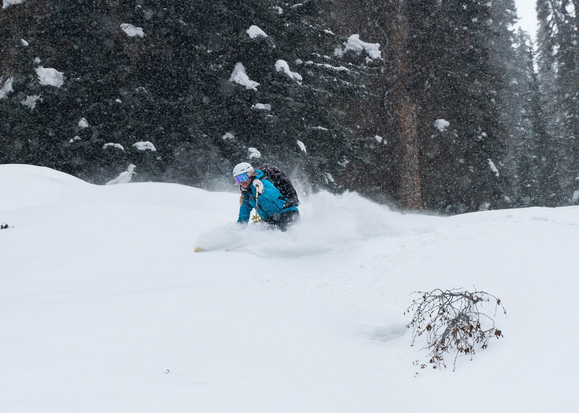 woman skiing down a snowy slope