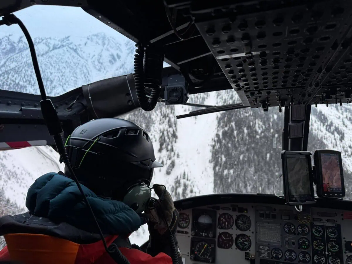 ski guide in a helicopter while heli skiing