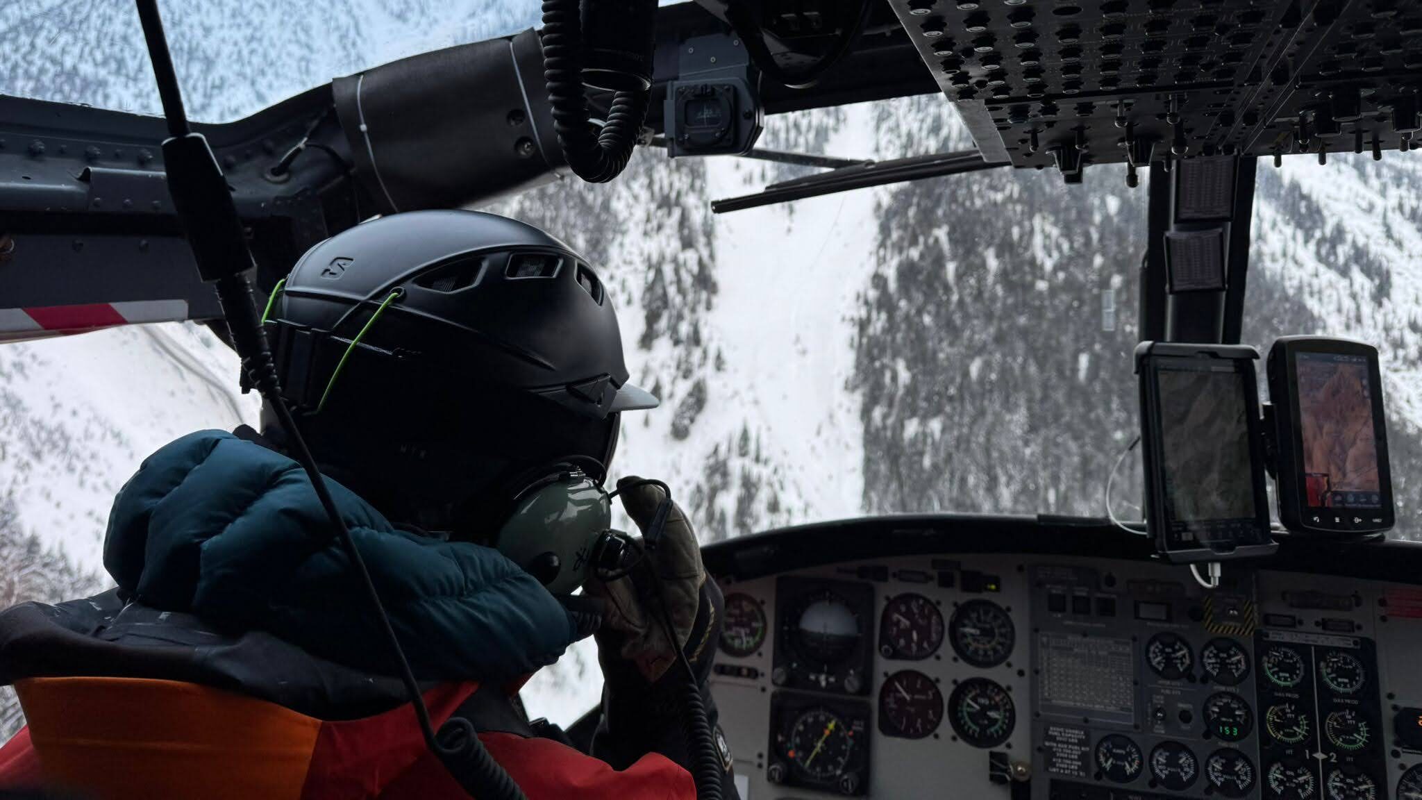 ski guide in a helicopter while heli skiing