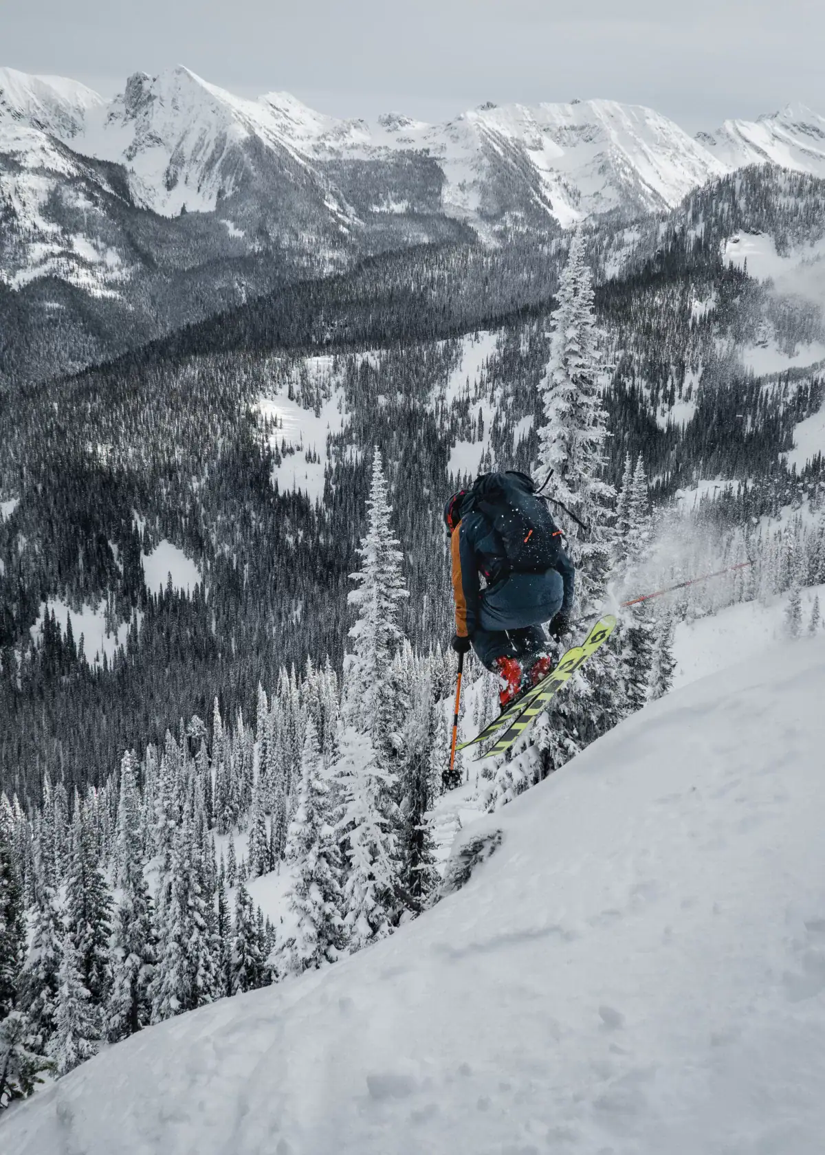 skier jumping off a pillow in greely trees
