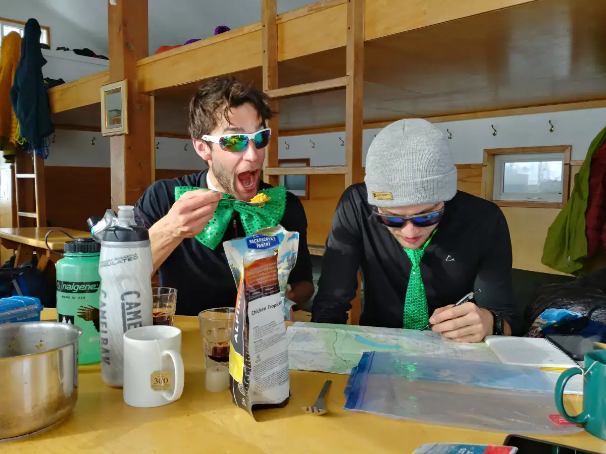 two men working on their mapping skills on a backcountry hut trip