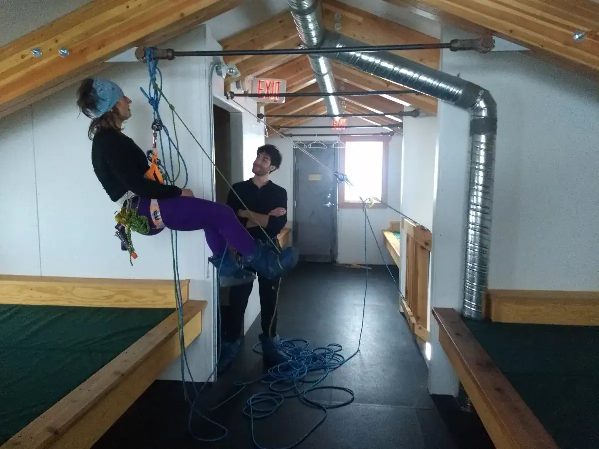 a woman and a man practicing crevasse rescue in preparation for the ski touring season