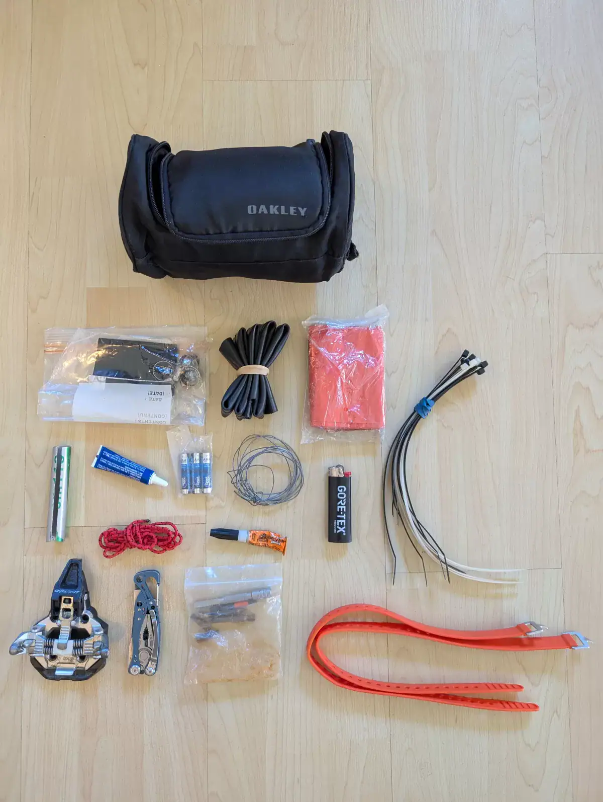 overhead view of the contents of a backcountry skiing repair kit