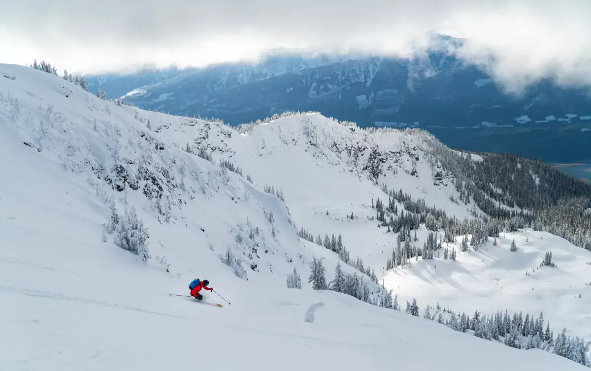 skier racing down montana peak in a white snowy bowl