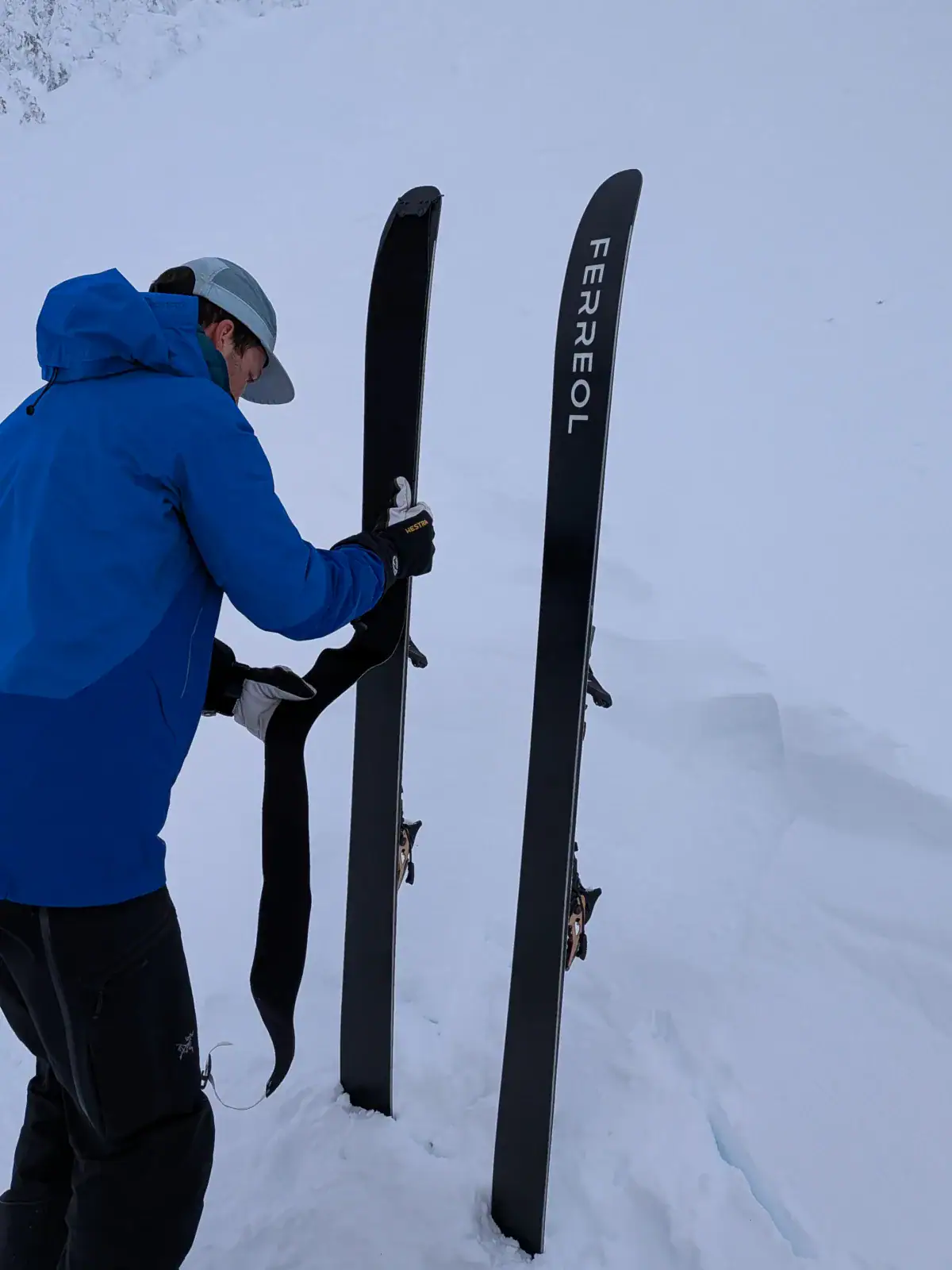 skier setting up climbing skins on ferreol skis