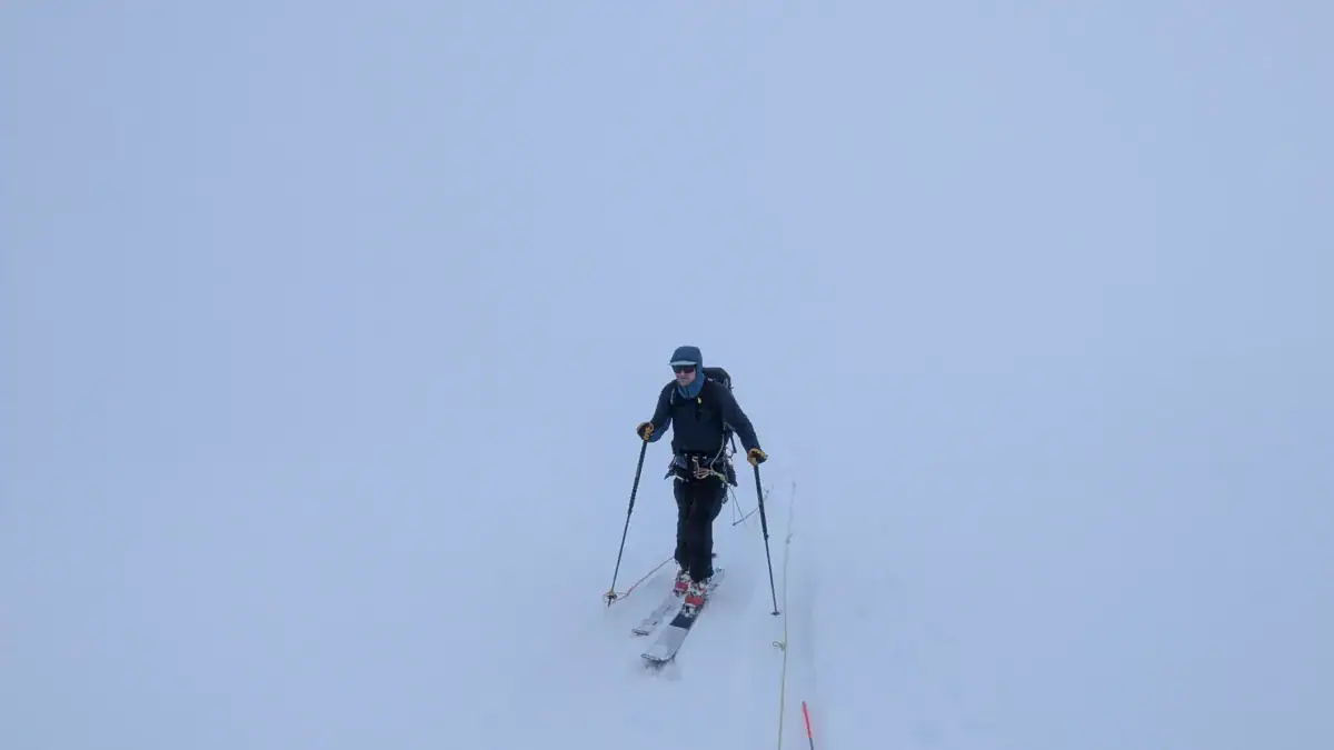 acmg ski touring guide travelling on a glacier in a whiteout