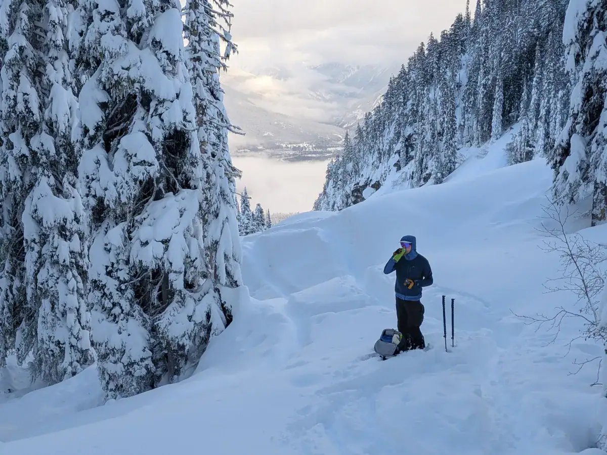 backcountry skier taking a break below fuzzy knob