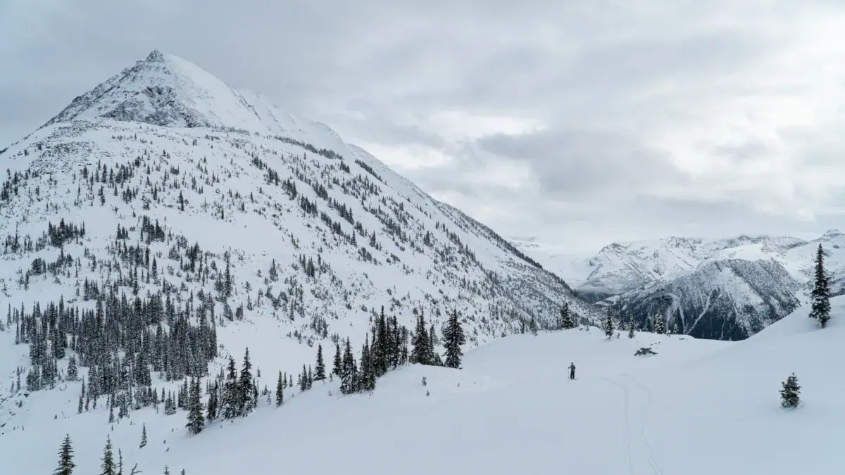 skier climbing towards the cheops west ridge