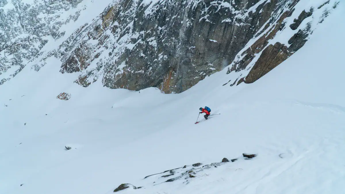 skier descening the top of cheops north bowl