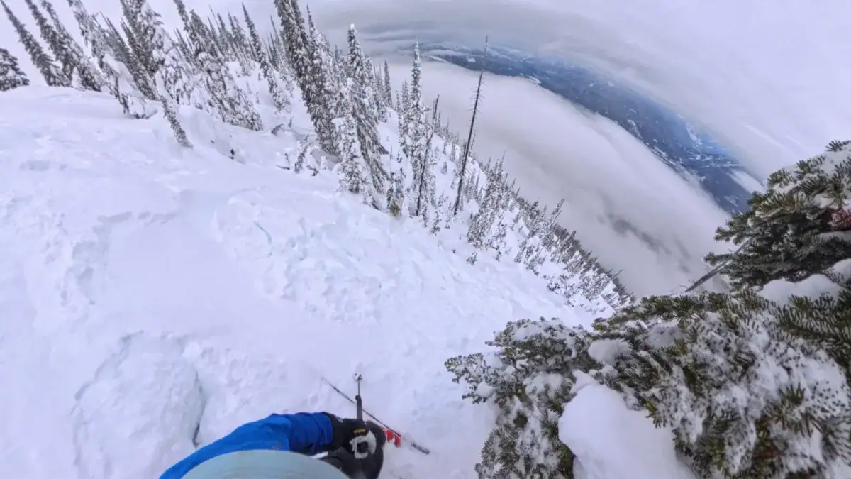 skier ski cutting a wind slab on burnt knob in revelstoke