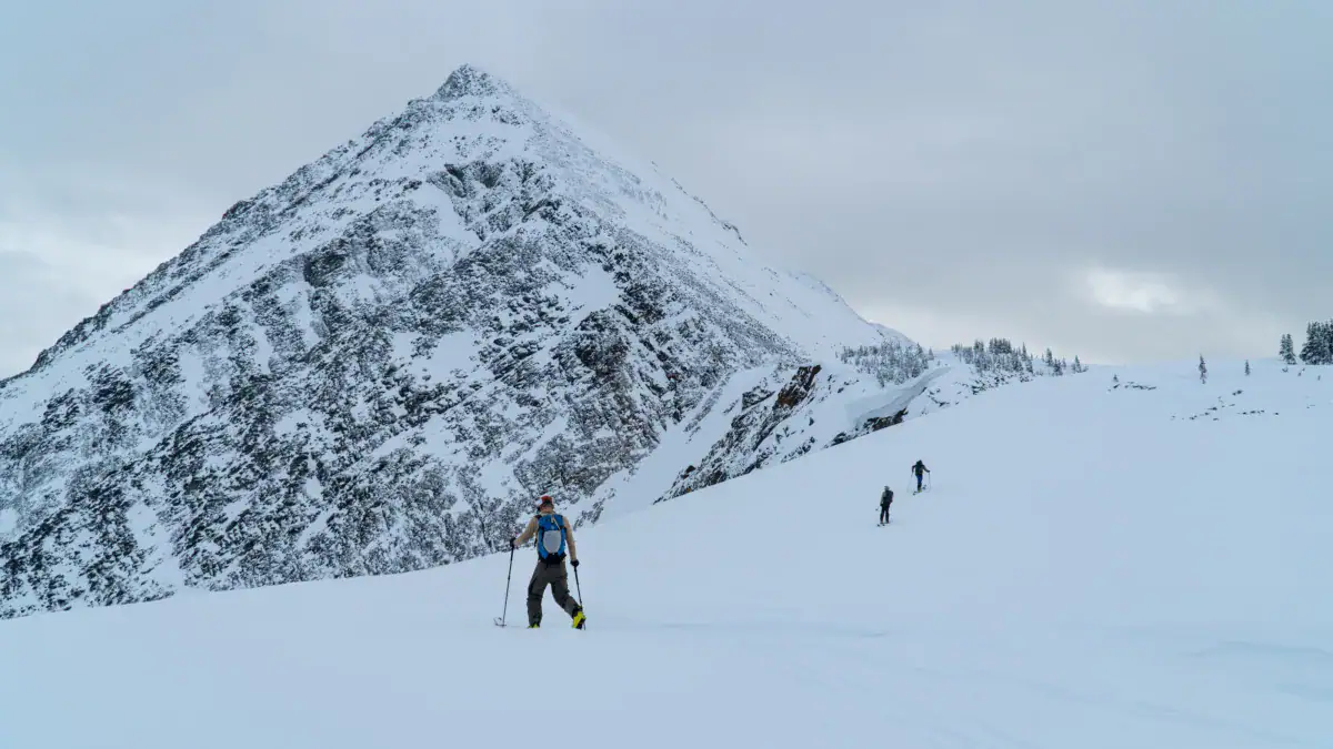 skier traversing above the entrance of cheops north bowl